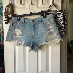 Ripped jean shorts. Size 13. Cute flower detail on back pocket. cheeky.